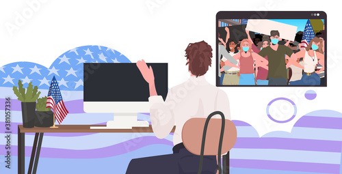man watching online video people in masks holding usa flags labor day celebration coronavirus quarantine self isolation concept office interior horizontal portrait vector illustration