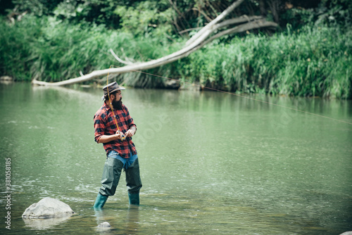 Portrait of cheerful bearded man fishing. Fisherman with fishing rod. Weekends made for fishing. Giving your hobby. With rod and in hat. Set up rod with hook line sinker.