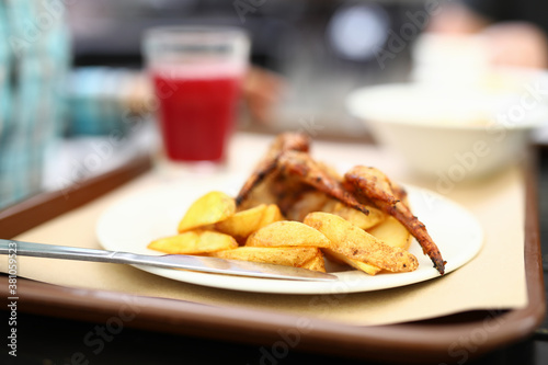 Potatoes and grilled chicken wings on plate. Blog about cooking concept