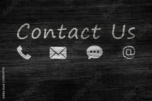 Call Center and Contact US Concept : Contact icon symbols and text wording on dark wall grunge texture background.
