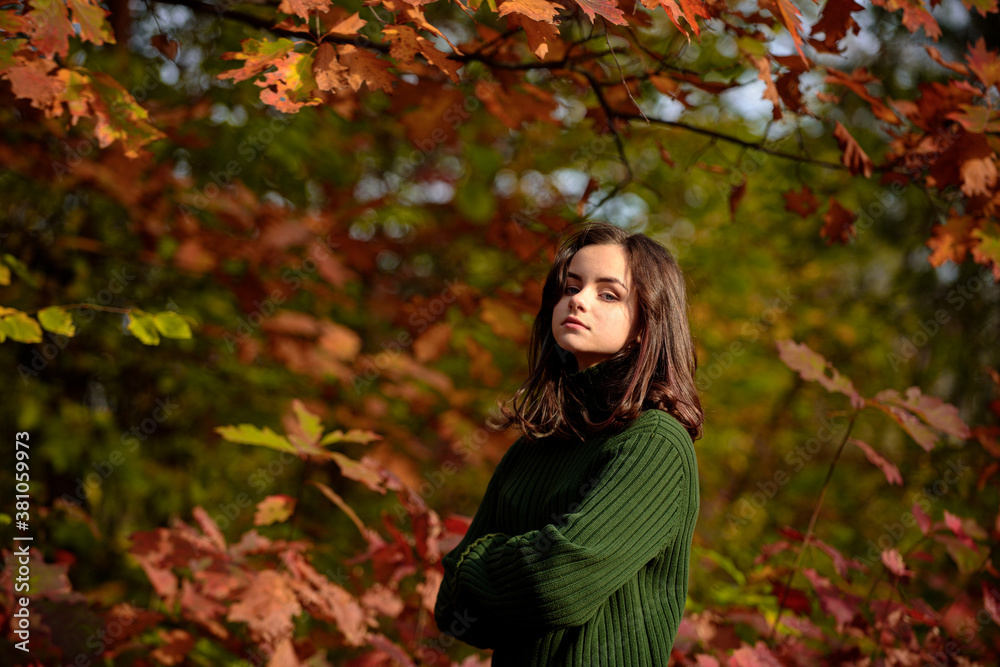 Teenage girl enjoying autumn weather. People on yellow foliage background. Teenage girl enjoying autumn weather. People on yellow foliage background.