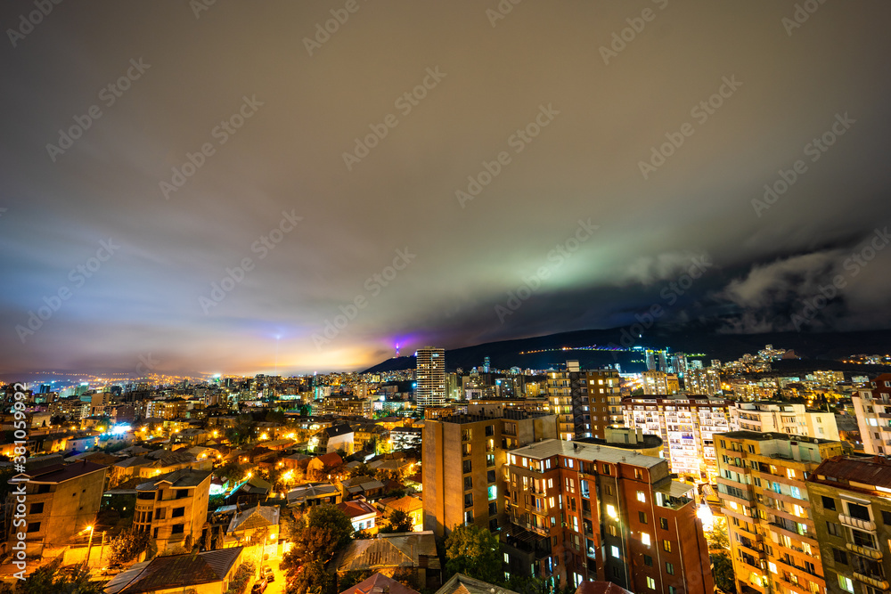 Fototapeta premium Dramatic night sky over Tbilisi city, Georgia