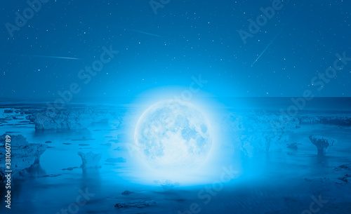 Full moon in the sea, falling star in the background "Elements of this image furnished by NASA