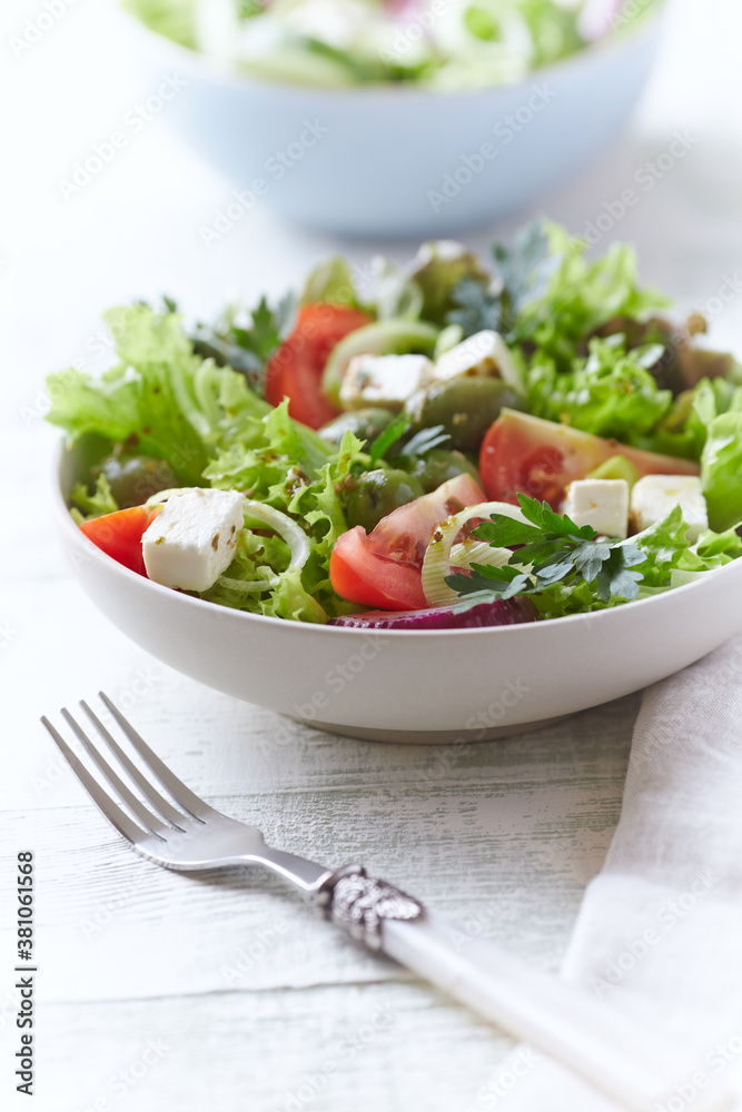 Salad with Green Olives, Tomatoes and Feta Cheese. Bright wooden background. Salad with Green Olives, Tomatoes and Feta Cheese. Bright wooden background.