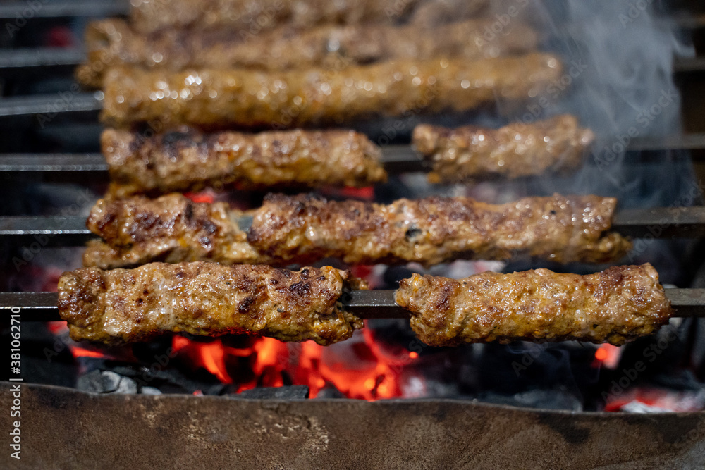 Sheekh Kabab being cooked over a charcoal grill