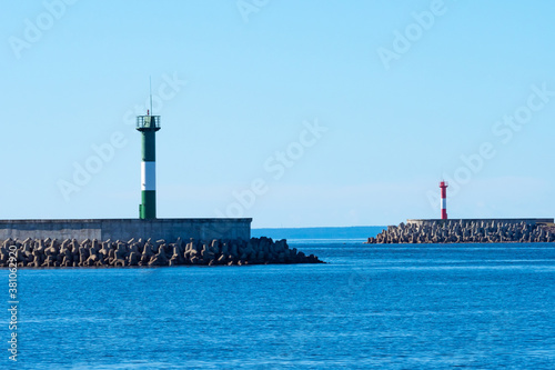 Lighthouses in Russia. Kronstadt Island in Saint Petersburg. Port Constantine. Lighthouses are standing on rocky shore. Washers on skyline. Red white lighthouses in Kronstadt. Sights St. Petersburg