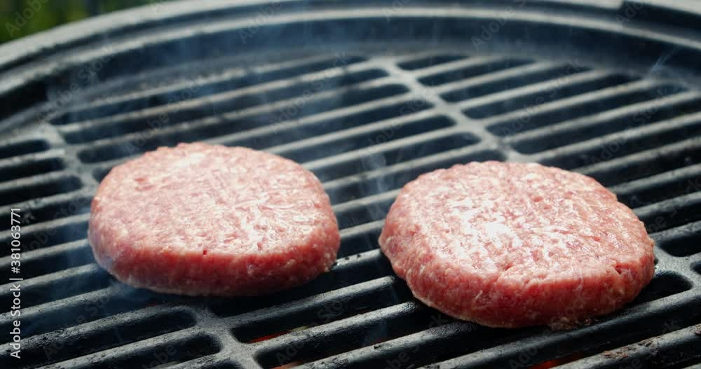 The burger is grilled with flames and smoke. The burger is grilled with flames and smoke.