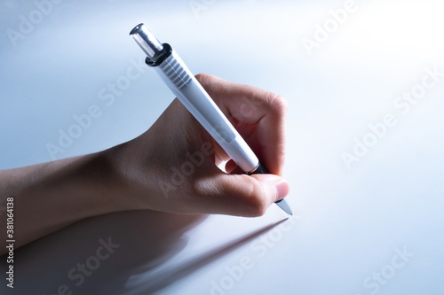 Ballpoint pen in hand close...