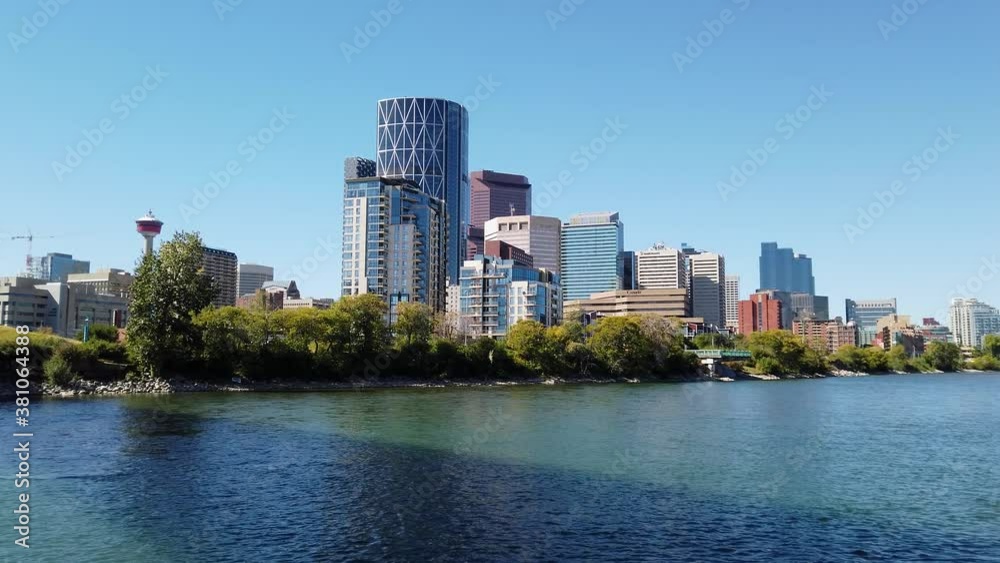 Calgary Skyline sits behind the Bow River on a clear summer day Calgary Skyline sits behind the Bow River on a clear summer day