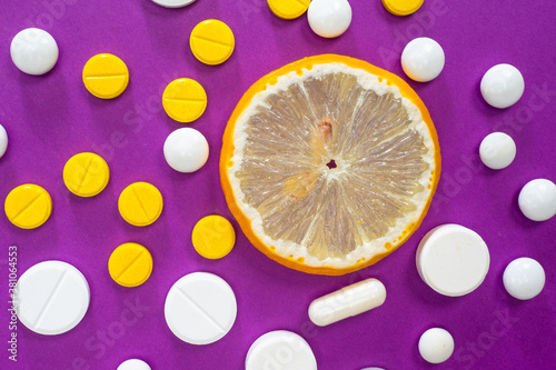 Vitamins. Pills and a slice...