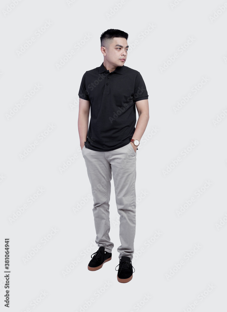 Fototapeta premium Full body shot of Handsome man wearing black polo shirt posing at plain background