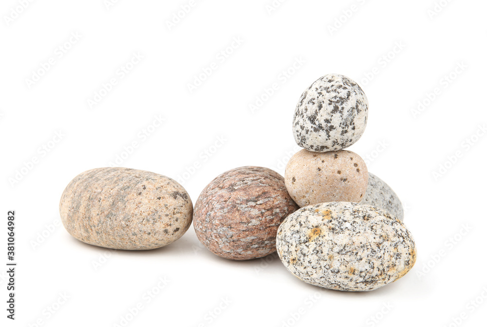 Sea smooth oval pebbles isolated on white background. Heap of stacked round pebbles. Sea smooth oval pebbles isolated on white background. Heap of stacked round pebbles.