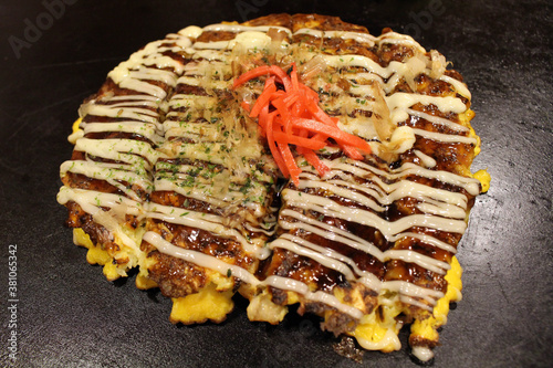 Closeup of Okonomiyaki, Japanese pizza is being cooked