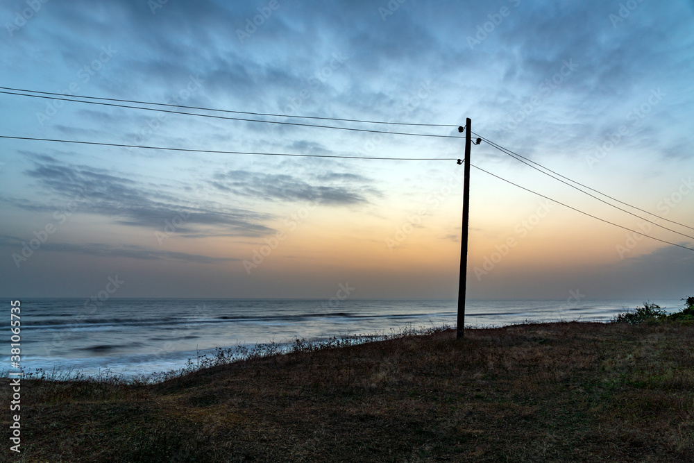 Power line pillar along the sea