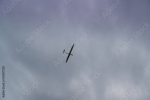 a glider towed by a plane in cloudy sky