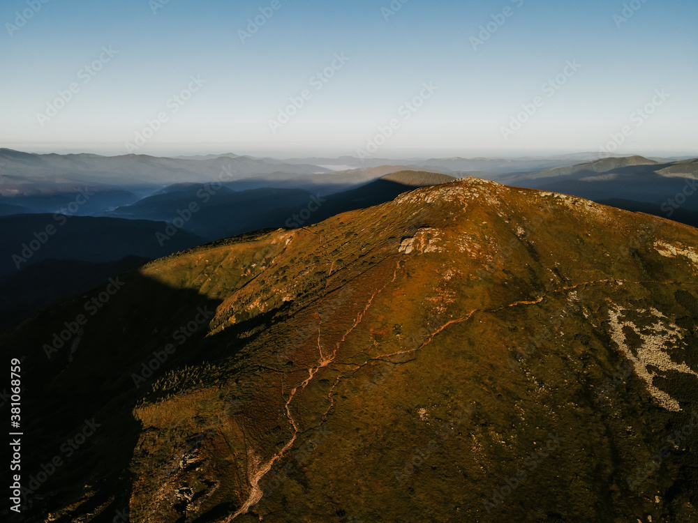 View of the Carpathian Mountains. Green forest against the sky, rocky mountains and beautiful landscape. Golden autumn in the mountain and forest