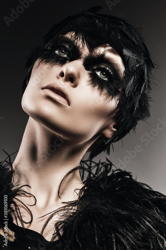 sexy woman with black feather on eyes
