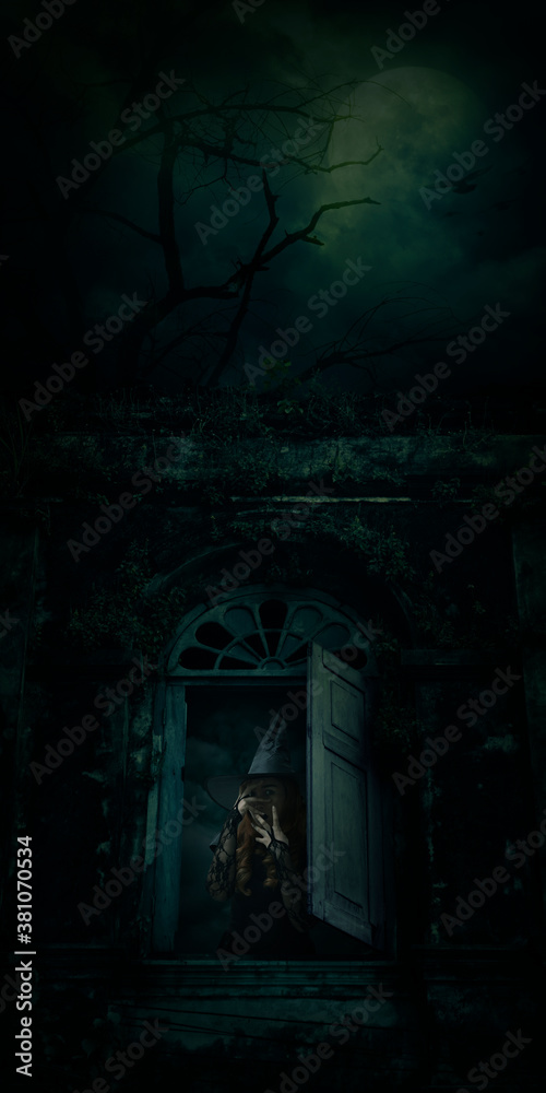 Scary halloween witch standing over ancient castle window, full moon with spooky cloudy sky, Halloween mystery concept