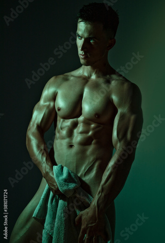 Male model with perfect body with a towel. Close-up. Studio shot.