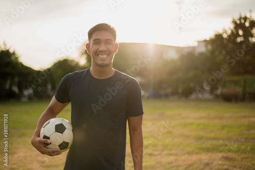 Male soccer football player. man soccer player smiling in field. © sarayutsridee
