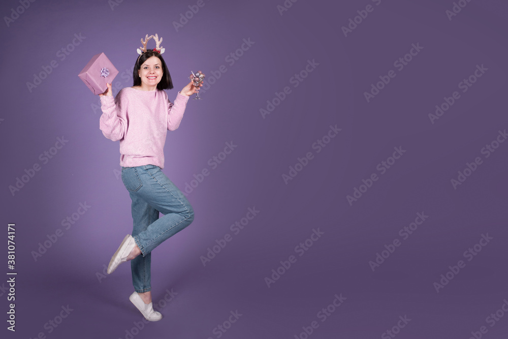 Happy Christmas woman with gift and Xmas decorations on purple banner background with copy space