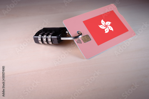 Padlock closed around a credit card with the flag of Hong Kong, concept of online payment, China Digital Currency and credit card data security and encryption photo