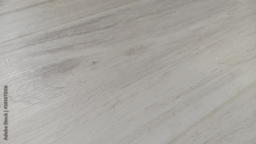 Light grey laminate texture, close-up. Beautiful textured wood floor. Light grey laminate texture, close-up. Beautiful textured wood floor.