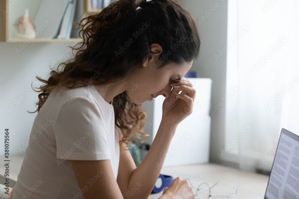 Exhausted young Caucasian woman massage eyes suffer from dizziness or blurry vision overwork on computer. Tired female feel unwell have migraine or headache overwhelmed with laptop work. Exhausted young Caucasian woman massage eyes suffer from dizziness or blurry vision overwork on computer. Tired female feel unwell have migraine or headache overwhelmed with laptop work.