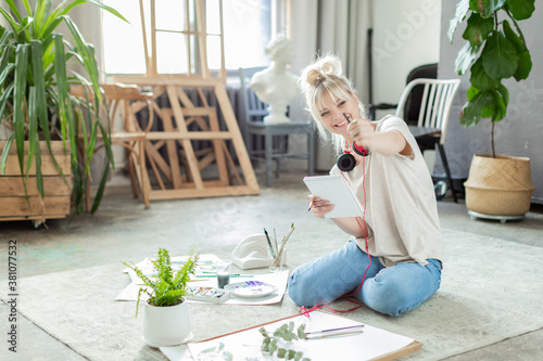 Obraz na plátně Happy laughing girl artist, painter, designer working at studio workshop