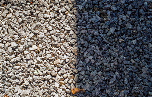 Difference concept. half gravel is in sun and half is shadow. Gravel pattern