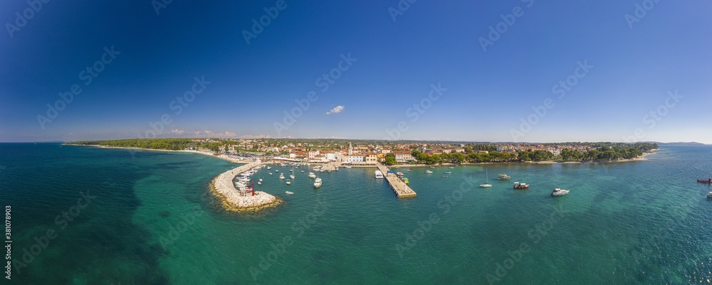 Panoramic aerial drone picture over the Istrian town of Fazana with harbour during daytime