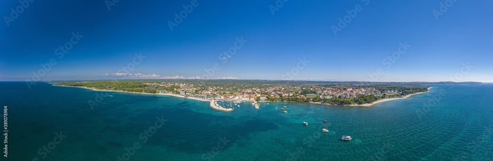 Panoramic aerial drone picture over the Istrian town of Fazana with harbour during daytime