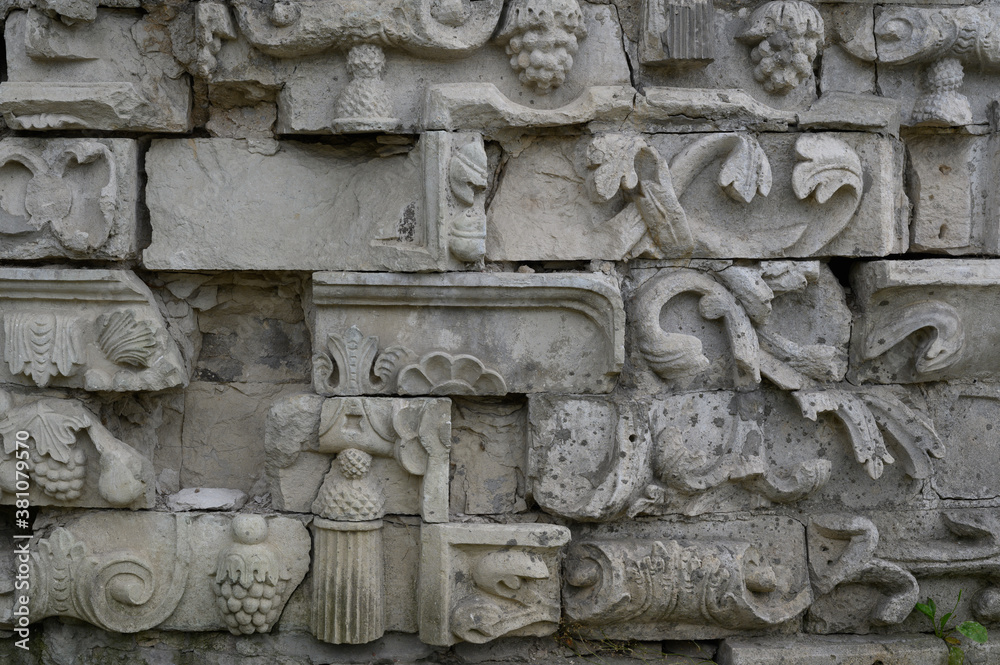stone bas-relief with floral and object ornaments