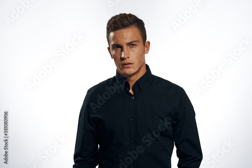 manager in black shirt official cropped view light background