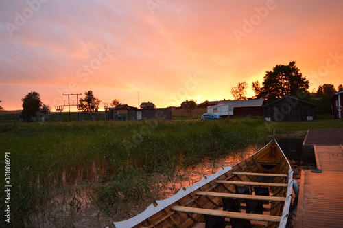 Stunning red and purple sunset and rainbows over Dalarna County in Sweden photo