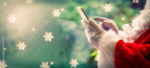 santa claus using mobile phone, close up view
