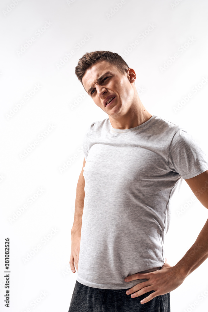 sporty man in white t-shirt on a light background gesturing with his hands cropped view Copy Space sporty man in white t-shirt on a light background gesturing with his hands cropped view Copy Space