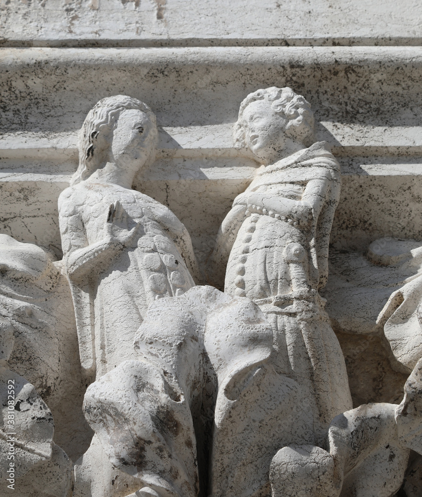 Venice, VE, Italy - July 13, 2020: Ancient sculpture of two youn