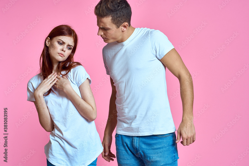 lovers man and woman in jeans and t-shirt on pink background cropped view family romance teenagers lovers man and woman in jeans and t-shirt on pink background cropped view family romance teenagers