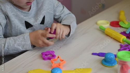 3 years girl creative arts. Child hands playing with colorful clay. Plasticine. play dough. Self-isolation Covid-19, online education, homeschooling. Toddler girl studying at home, home learning. photo