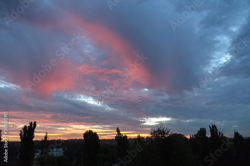 Multi-colored clouds in the sky before sunrise.