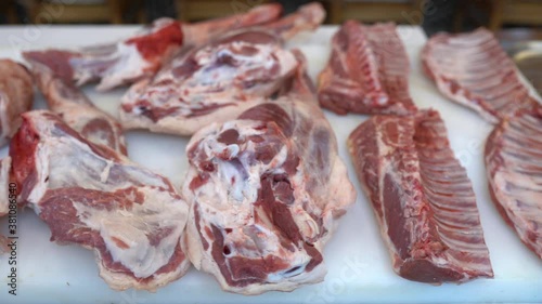 Worker using knife cutting pieces of lamb meat. Deboning of lamb meat. Butcher in gloves cuts carcass of red meat into pieces. Video photo