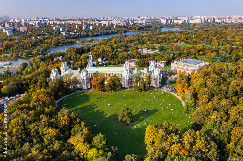a panoramic view of the ancient palace and a large green park complex with a lake filmed from a drone