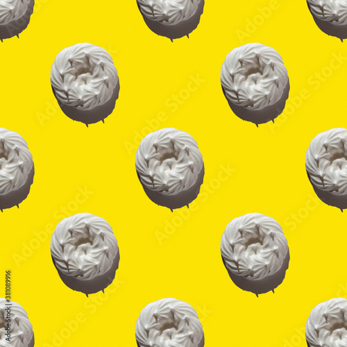 seamless pattern of beautiful white meringue on a bright yellow background. Top view, flat lay, food background
