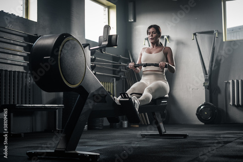 Beautiful Woman Has Arms Workout On Rowing Machine .