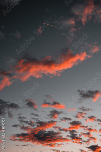 Colorful and dramatic sunset view with illuminated clouds and burning sky and nature countryside view