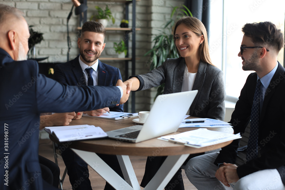Fototapeta premium Business people shaking hands, finishing up a meeting.
