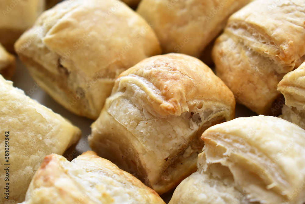 Sausage roll savoury pastry snack on a white plate. Sausage roll savoury pastry snack on a white plate.