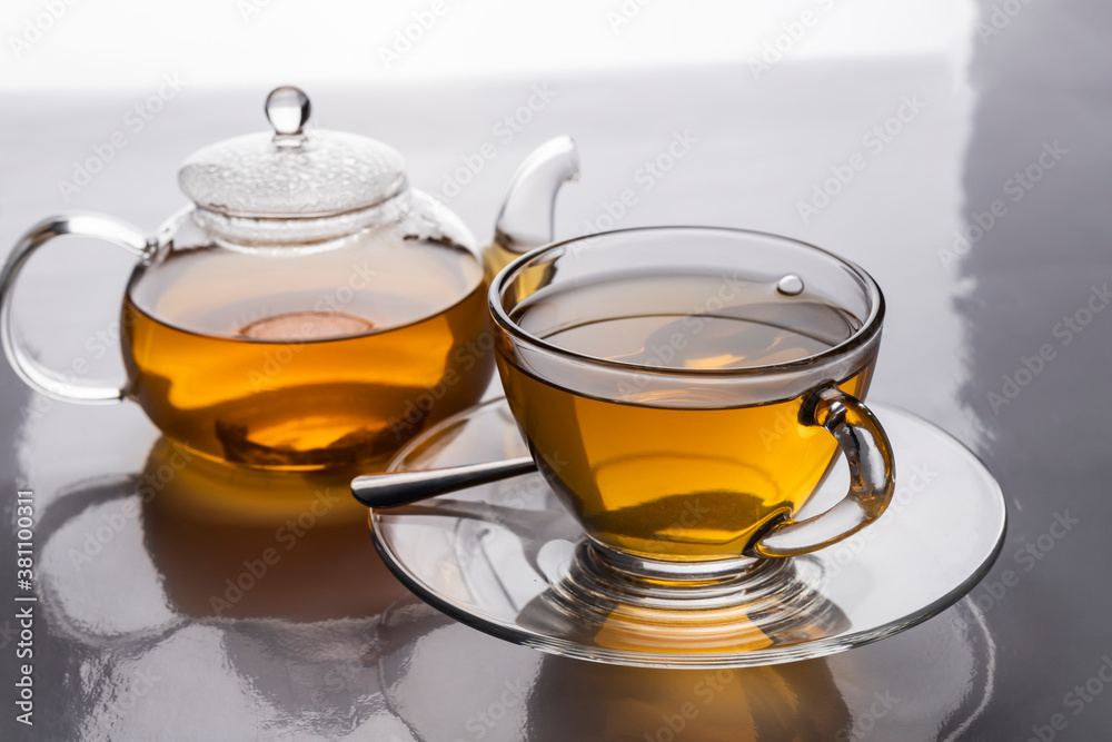 The hot teacup and teapot transparent on the table The hot teacup and teapot transparent on the table