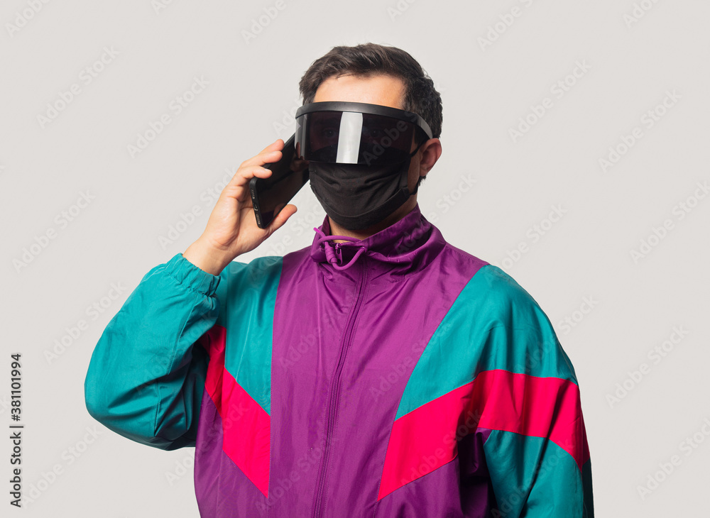 Style guy face mask and futuristic glassses with mobile phone